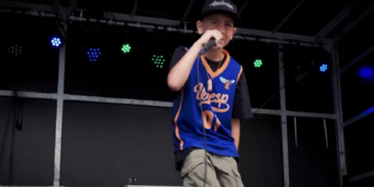 A 12-year-old boy sings a rap song