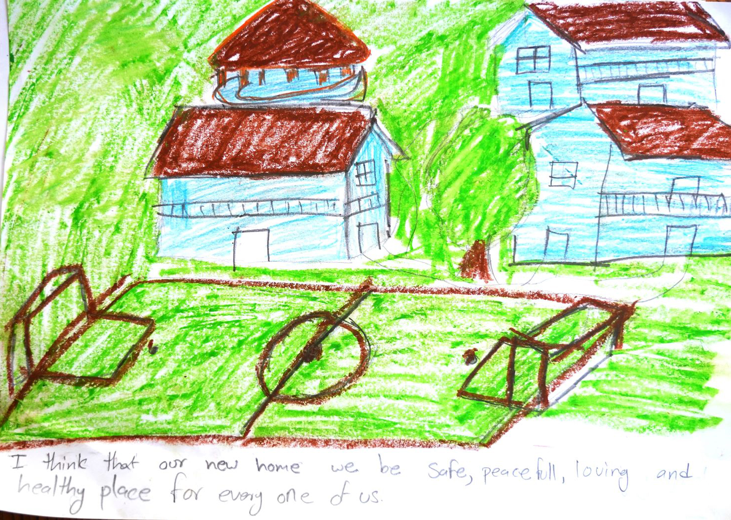 Child's drawing of houses surrounded by trees with a green playground featuring a central sports field. The text reads, "I think that our new home will be a safe, peaceful, loving and healthy place for every one of us.