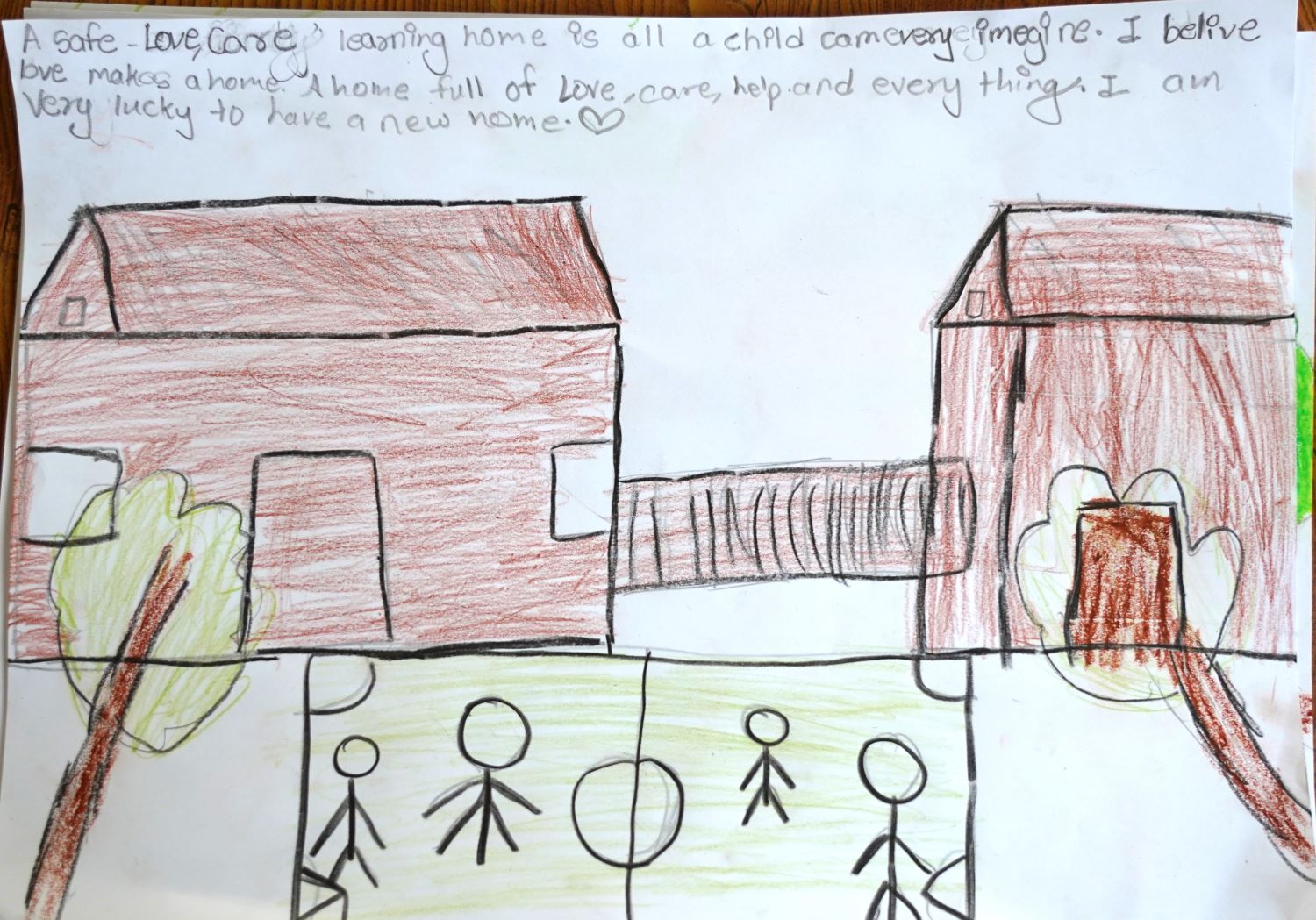 A child's drawing of two houses with a yard and stick figures on a play area. Text at the top expresses a desire for a loving and caring home, mentioning feeling lucky to have a new home. Heart symbol included.